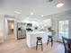 Modern kitchen with stainless steel appliances, a center island, and white cabinets, offering both style and functionality at 9929 Bay Dr, Gibsonton, FL 33534