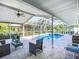 Enclosed pool with patio furniture for relaxing and beautiful backyard views at 9929 Bay Dr, Gibsonton, FL 33534
