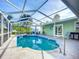 Enclosed pool with an attached spa and serene surroundings offering a private backyard oasis for relaxation and enjoyment at 9929 Bay Dr, Gibsonton, FL 33534