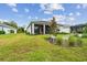 Spacious backyard featuring a screened in lanai, landscaped features and views of surrounding homes at 10036 Beachwalk Dr, Englewood, FL 34223
