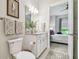 Well-lit bathroom with neutral tones, vanity, and a view into a bedroom with a king bed at 10036 Beachwalk Dr, Englewood, FL 34223
