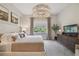 Inviting bedroom with soft lighting, king-sized bed and views of a lush green outside at 10036 Beachwalk Dr, Englewood, FL 34223