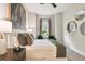 Bedroom featuring a queen-sized bed, neutral carpet flooring, and natural lighting at 10036 Beachwalk Dr, Englewood, FL 34223