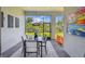 Bright dining room with glass table, outdoor view and brick floors for elegant entertaining at 10036 Beachwalk Dr, Englewood, FL 34223