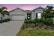 Charming single-story home featuring a well-manicured lawn, a two-car garage, and a welcoming front entrance at 10036 Beachwalk Dr, Englewood, FL 34223
