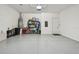 Clean and organized garage space with ample storage, epoxy flooring, and overhead lighting at 10036 Beachwalk Dr, Englewood, FL 34223