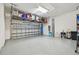 Spacious garage featuring epoxy flooring, overhead storage, and ample room for parking and projects at 10036 Beachwalk Dr, Englewood, FL 34223
