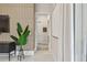 Hallway leading into other areas with accent wall, plant and bright lighting at 10036 Beachwalk Dr, Englewood, FL 34223