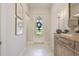 Inviting hallway featuring a decorated front door, stylish furnishings, and modern decor, enhancing its appeal at 10036 Beachwalk Dr, Englewood, FL 34223
