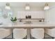 Bright kitchen featuring a large center island with seating, stylish pendant lighting, and modern appliances at 10036 Beachwalk Dr, Englewood, FL 34223