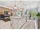 Bright, open kitchen showcasing an island with seating, sleek appliances, and modern pendant lighting at 10036 Beachwalk Dr, Englewood, FL 34223