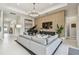 Bright living room featuring a grand piano, stylish decor, and comfortable seating arrangement at 10036 Beachwalk Dr, Englewood, FL 34223