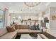 Open living space with modern kitchen featuring stainless steel appliances and a large comfortable sofa at 10036 Beachwalk Dr, Englewood, FL 34223
