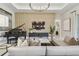 Sophisticated living area showcasing a grand piano, stylish decor and a seamless flow to adjacent rooms at 10036 Beachwalk Dr, Englewood, FL 34223