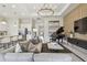 Open-concept living room featuring modern decor, piano, and access to the kitchen and other living areas at 10036 Beachwalk Dr, Englewood, FL 34223