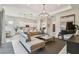 Open-concept living room and kitchen area with modern furnishings, a piano, and abundant natural light at 10036 Beachwalk Dr, Englewood, FL 34223