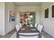 Covered patio with dining table set, sliding doors, and view of the backyard at 10036 Beachwalk Dr, Englewood, FL 34223