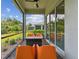 Screened patio with comfortable seating offers a relaxing outdoor space with a view of lush greenery at 10036 Beachwalk Dr, Englewood, FL 34223