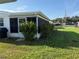 Well-maintained backyard with a screened-in lanai and lush green lawn, offering a private outdoor space at 10169 45Th N St, Pinellas Park, FL 33782