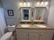Bathroom featuring double sinks, neutral decor, and excellent lighting at 10169 45Th N St, Pinellas Park, FL 33782