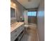 Bathroom with tiled shower, granite countertop and bright lighting at 10169 45Th N St, Pinellas Park, FL 33782
