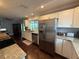 Spacious kitchen with modern appliances, granite counters, and sleek hardwood floors at 10169 45Th N St, Pinellas Park, FL 33782