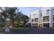 Modern condo exterior featuring garage parking, manicured landscaping, and private balconies at 1028 Sunset Point Rd # R4, Clearwater, FL 33755