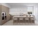 Modern kitchen with marble countertops, an island with seating, and stainless steel appliances at 1028 Sunset Point Rd # R4, Clearwater, FL 33755