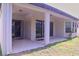 The covered patio features direct access to the backyard and home through sliding glass doors at 10431 Alcon Blue Dr, Riverview, FL 33578