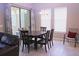 Cozy dining room with sliding glass doors, natural light, and comfortable seating for six at 10431 Alcon Blue Dr, Riverview, FL 33578