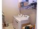 Well-lit laundry room with a modern washer and dryer set and storage shelves at 10431 Alcon Blue Dr, Riverview, FL 33578