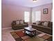 Well-lit living room features two sofas, a coffee table, and tile flooring at 10431 Alcon Blue Dr, Riverview, FL 33578