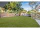 A freshly manicured lawn surrounded by new wooden fencing offers privacy in this backyard at 1052 55Th N Ave, St Petersburg, FL 33703