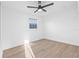 An empty bedroom featuring neutral paint, wood-look floors, and a ceiling fan at 1052 55Th N Ave, St Petersburg, FL 33703