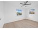 An empty bedroom with neutral paint, light-colored floors and a ceiling fan at 1052 55Th N Ave, St Petersburg, FL 33703