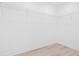 Bright walk-in closet features white walls, wooden floors, and wire shelving for storage at 1052 55Th N Ave, St Petersburg, FL 33703