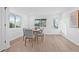 Sunlit dining room featuring sleek, modern chairs, light wood floors and crisp white walls at 1052 55Th N Ave, St Petersburg, FL 33703