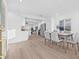 Bright, open-concept dining area with modern furnishings and seamless flow to the kitchen and living room at 1052 55Th N Ave, St Petersburg, FL 33703