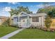 Well-maintained home with landscaping, a manicured lawn and a bright front door at 1052 55Th N Ave, St Petersburg, FL 33703
