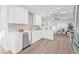 Stylish kitchen with white cabinetry, stainless steel appliances, light countertops, and a coffered ceiling at 1052 55Th N Ave, St Petersburg, FL 33703