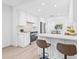 Open kitchen featuring white cabinets, stainless appliances, and a breakfast bar with seating at 1052 55Th N Ave, St Petersburg, FL 33703