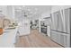 Open kitchen with stainless appliances, white cabinets and seamless flow to the living area at 1052 55Th N Ave, St Petersburg, FL 33703