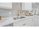 Bright kitchen showcases stainless steel sink, quartz countertops and elegant gold hardware at 1052 55Th N Ave, St Petersburg, FL 33703