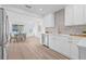 Bright, fully remodeled kitchen features white cabinets, stainless steel appliances, and an eat-in dining area at 1052 55Th N Ave, St Petersburg, FL 33703
