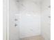 The new, tiled walk-in shower offers a sleek design with marble-like tiling, new fixtures and tiled flooring at 1052 55Th N Ave, St Petersburg, FL 33703