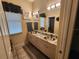 Bathroom with double sinks, granite countertops and a large mirror at 10532 Cory Lake Dr, Tampa, FL 33647