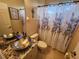 Bathroom featuring a vessel sink, granite countertop, and decorative shower curtain at 10532 Cory Lake Dr, Tampa, FL 33647