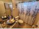 Bathroom featuring a vessel sink and shower with a floral shower curtain design at 10532 Cory Lake Dr, Tampa, FL 33647