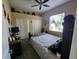 A quaint bedroom with a black bed frame and a ceiling fan at 10532 Cory Lake Dr, Tampa, FL 33647