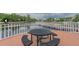 Lakeside deck features outdoor table and seating, perfect for relaxing and enjoying the water view at 10532 Cory Lake Dr, Tampa, FL 33647